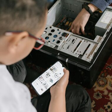 Person Holding White and Black Audio Mixer